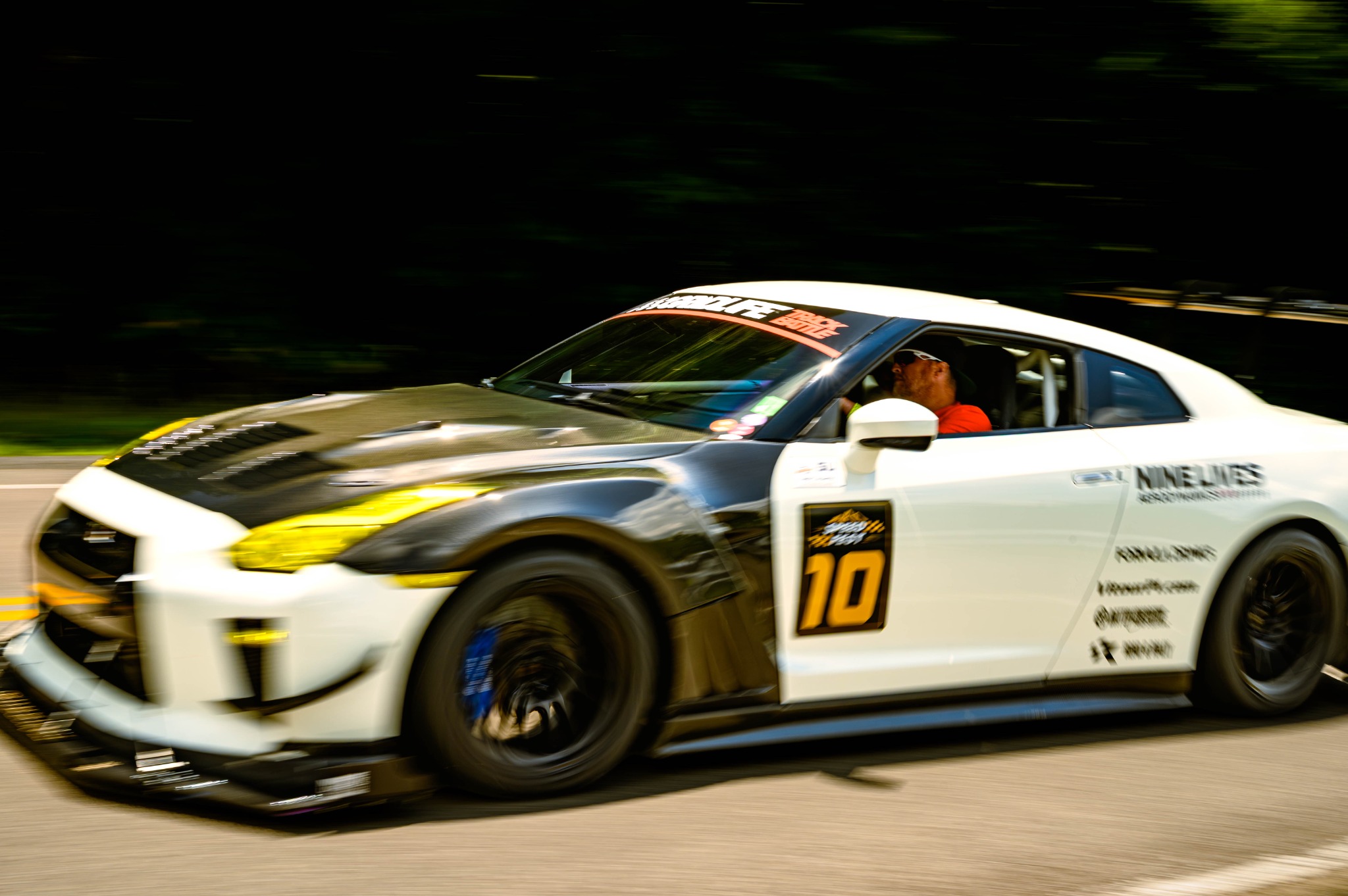 Race-prepared Nissan GT-R passing the photographer at speed